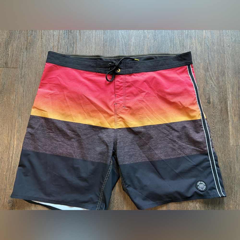 Size 40 Ron Jon surf shop board shorts.  Black, orange, grey.  Drawstring waist.